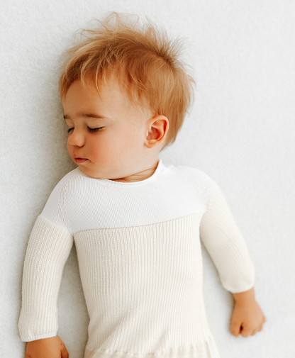 A toddler sleeping in a transition swaddle.