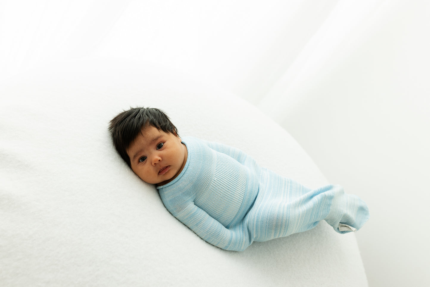 A baby moving in its soft sleep sack.