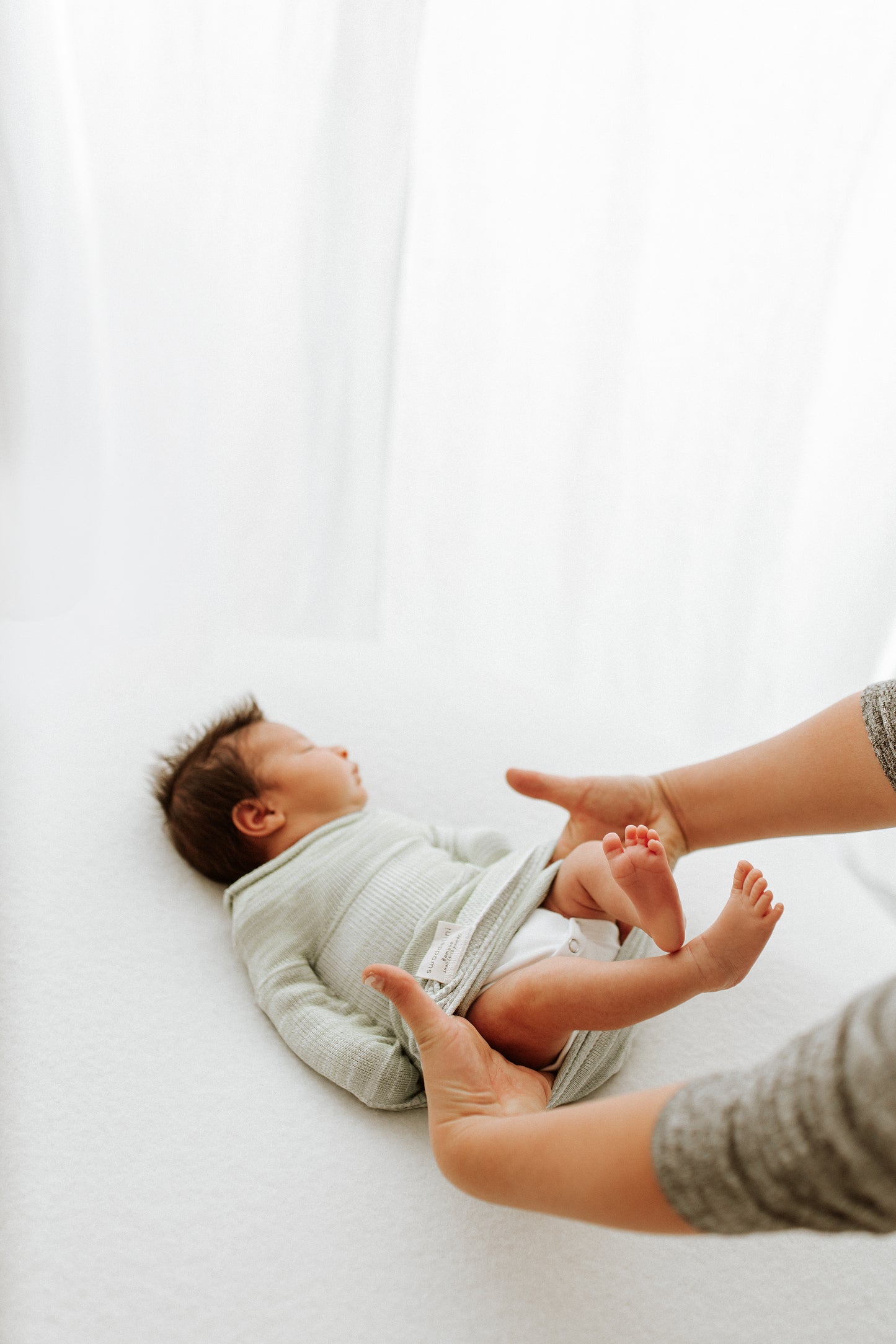 A newborn in a newborn swaddle.