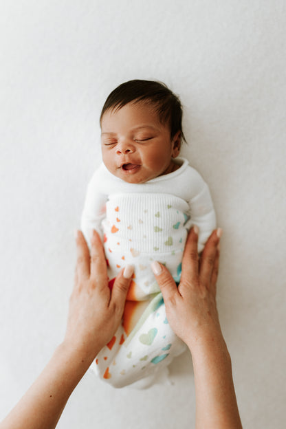 A baby resting in an infant sleep sack.