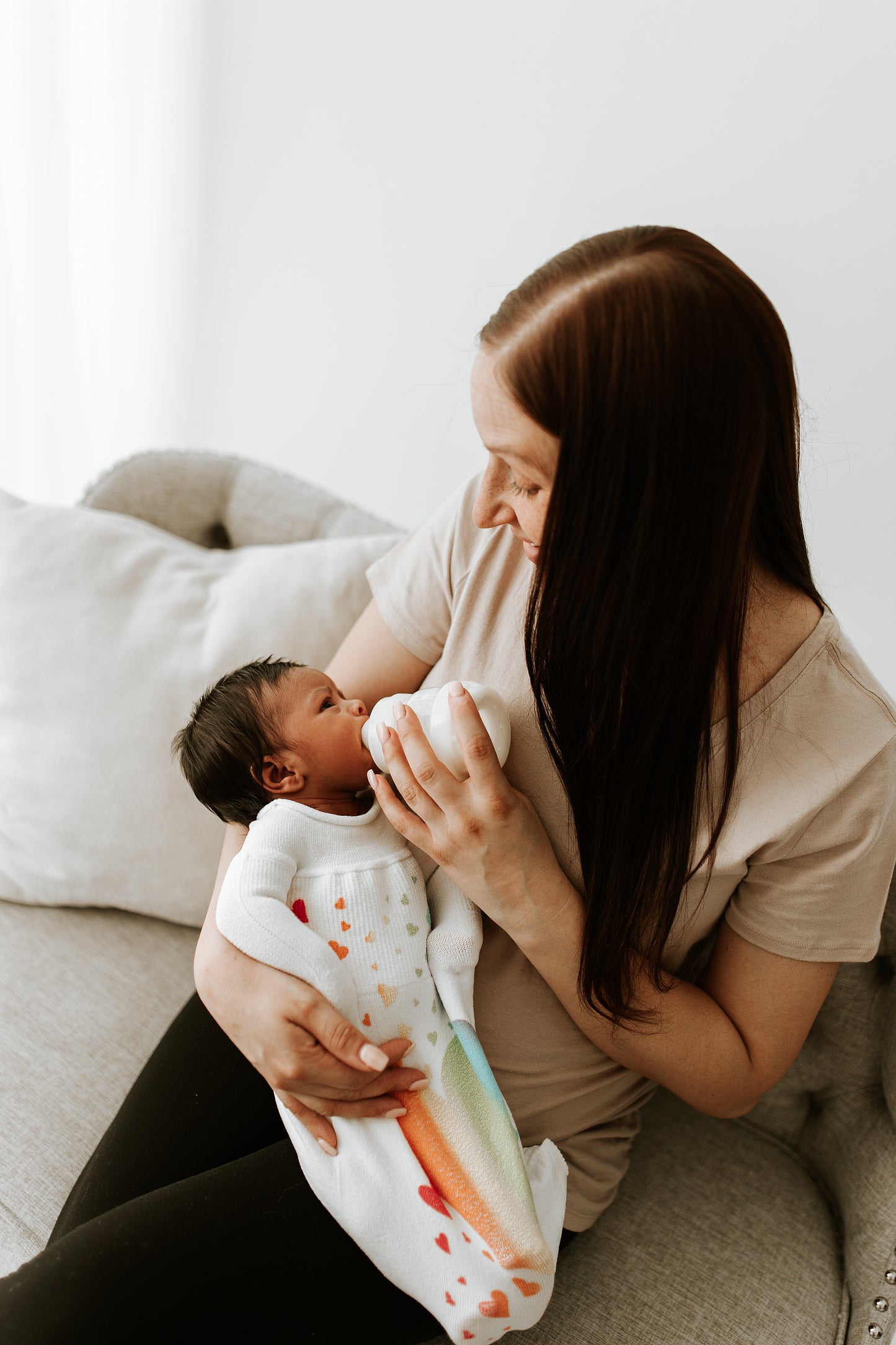 A baby feeding in a swaddle.