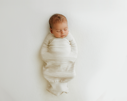 sleeping baby in bamboo beige swaddle
