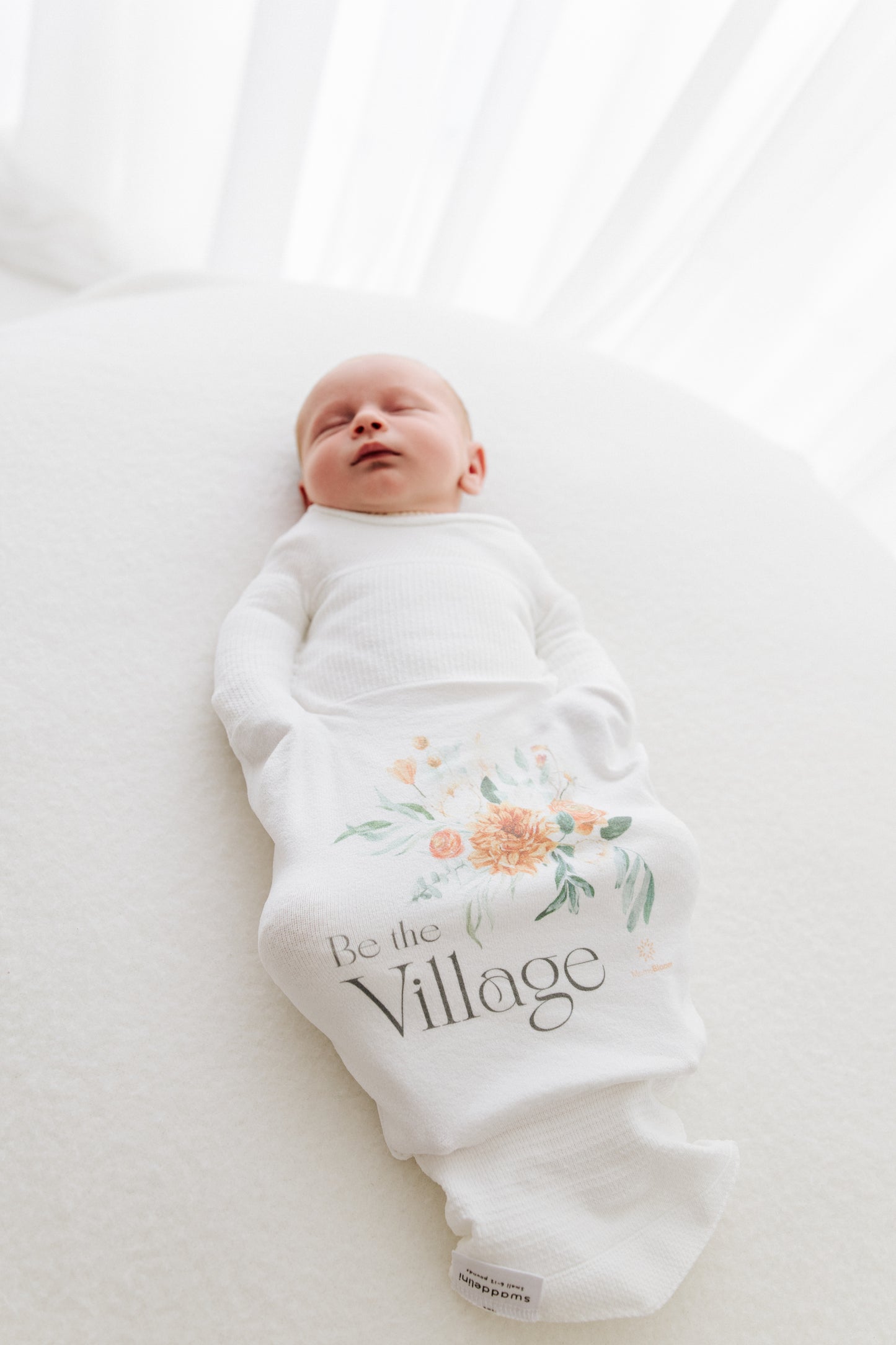 baby sleeping in safe sleepsack with good message to new mothers