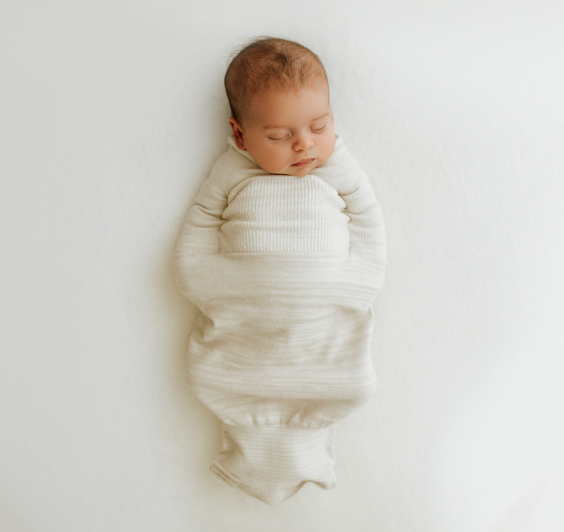 sleeping infant in newborn baby swaddle