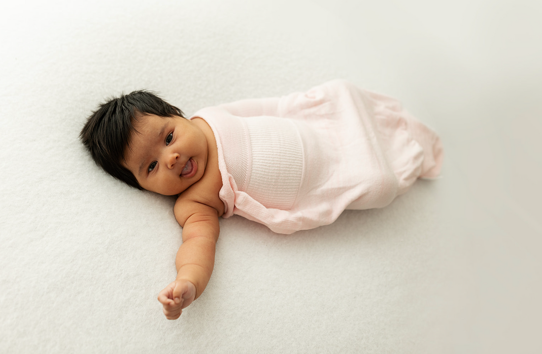 baby in a pink Swaddelini