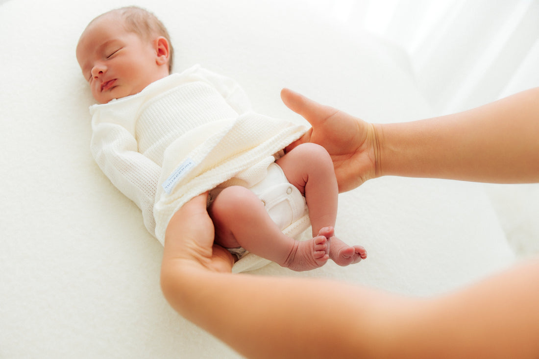 baby lying in a sleep sack