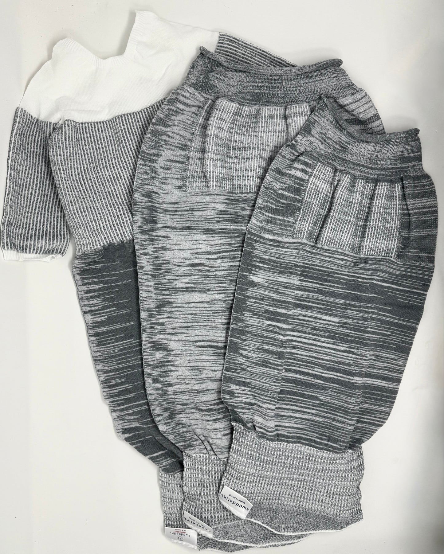 The Grey Swaddelini Sleep Sack Bundle is your complete safe sleep system — from newborn swaddle to arms-out sleep sack. Perfect for rolling babies