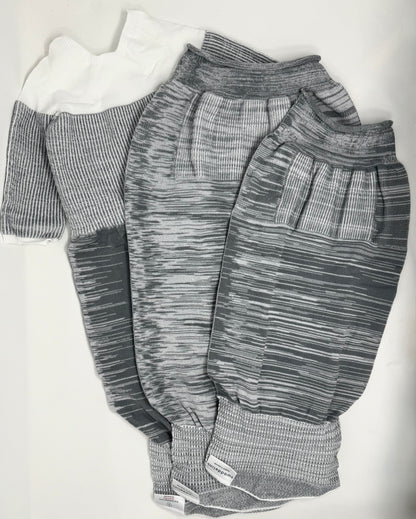 The Grey Swaddelini Sleep Sack Bundle is your complete safe sleep system — from newborn swaddle to arms-out sleep sack. Perfect for rolling babies