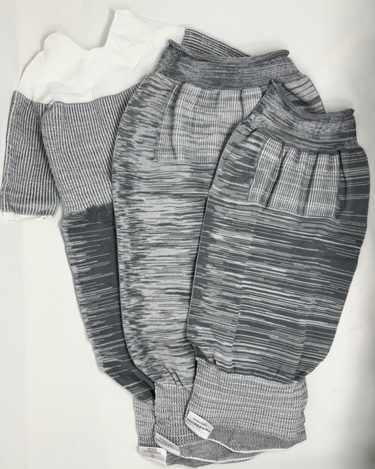 The Grey Swaddelini Sleep Sack Bundle is your complete safe sleep system — from newborn swaddle to arms-out sleep sack. Perfect for rolling babies